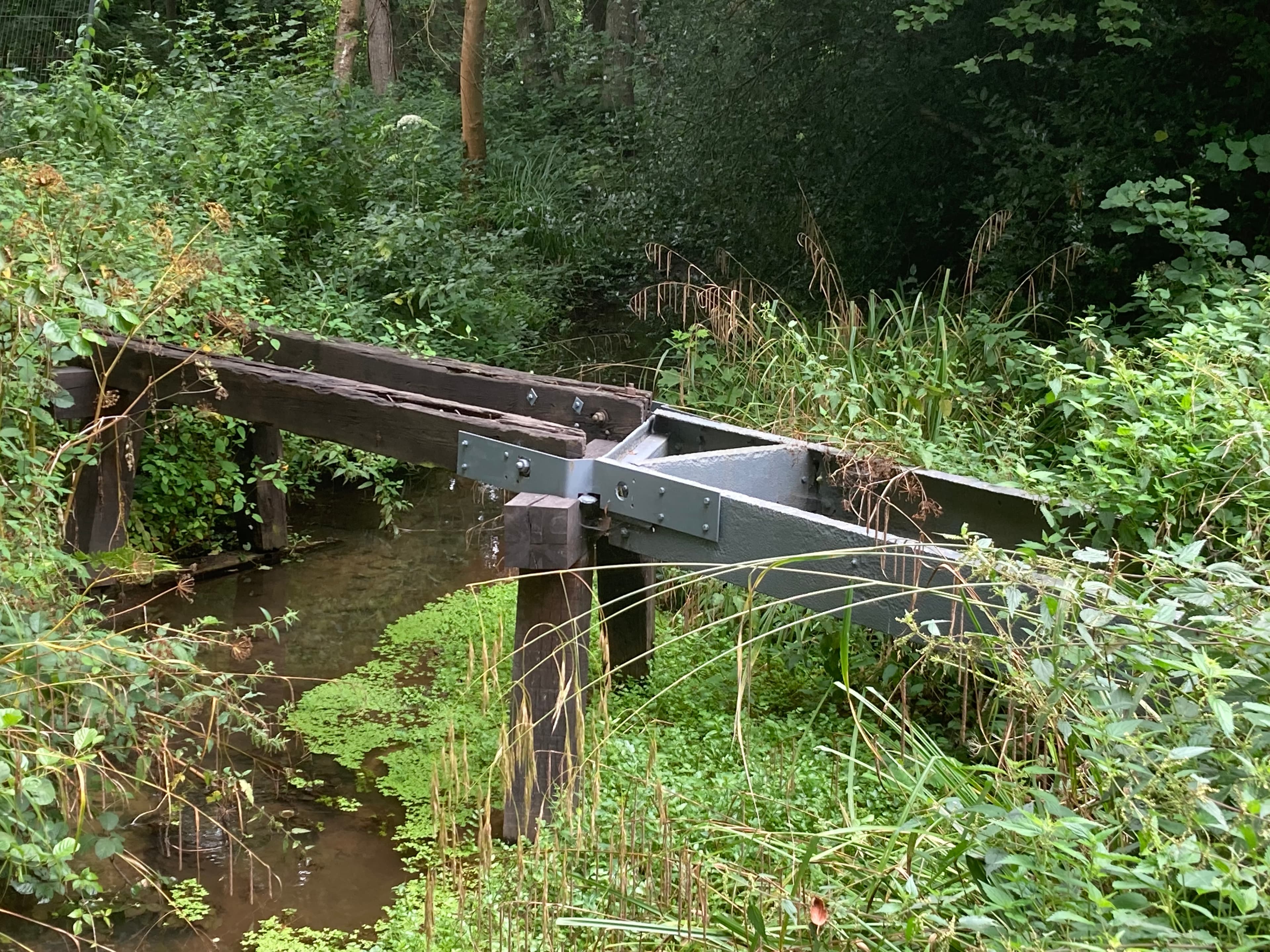 The old swing bridge in situ over the river Tillingbourne