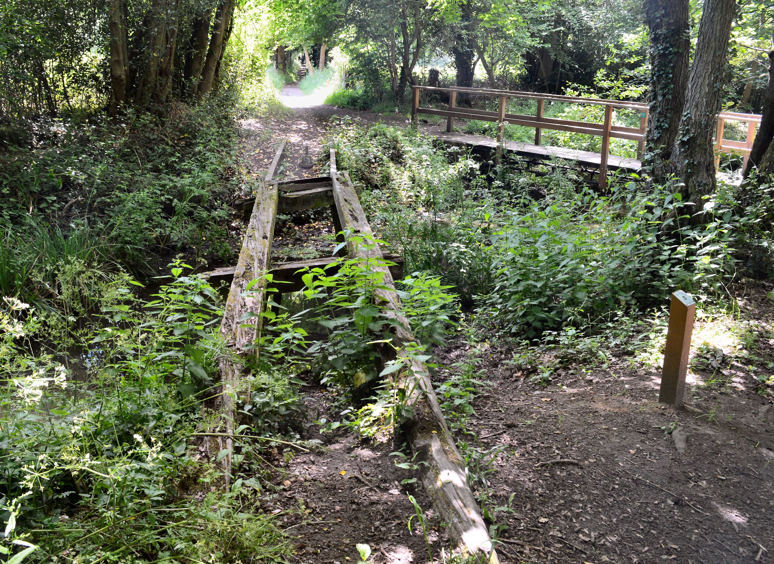 A view over the swing bridge and up the old tramway path